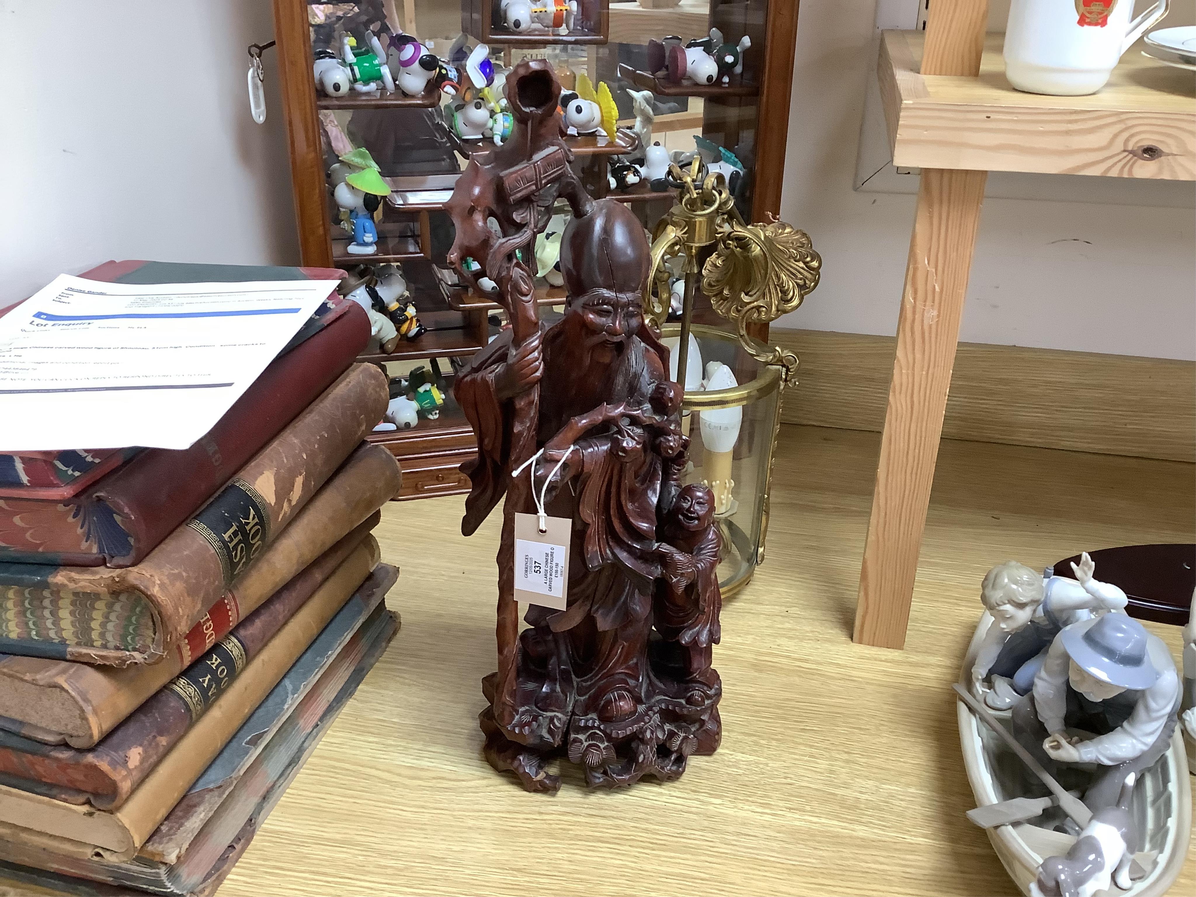 A large Chinese carved wood figure of Shouloau, 51cm high. Condition - some cracks to the wood